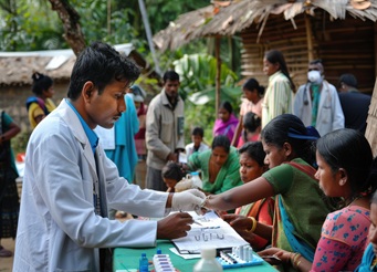 Doctor reviewing patient information during a community healthcare outreach program by Kurapati Healthcare Foundation